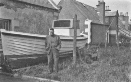 William's brother, James Clarence Alexander Pirie, with the completed boat in the back yard William's brother, James Clarence Alexander Pirie, with the completed boat in the back yard
