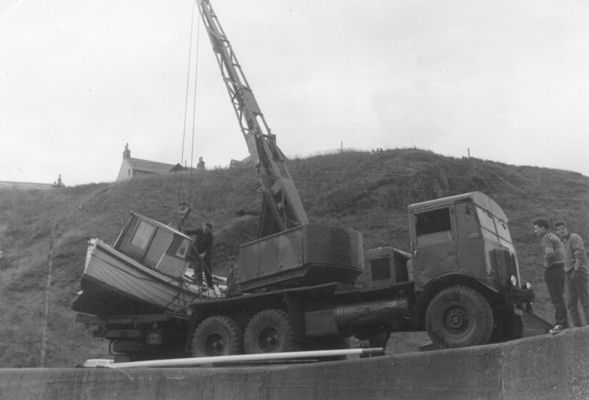 The crane about to lift the boat off the lorry