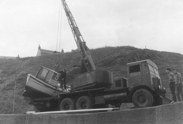 The crane about to lift the boat off the lorry The crane about to lift the boat off the lorry