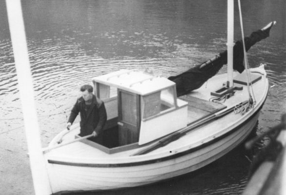 The boat is rigged with mast, spar, sail and tiller as the tide comes in