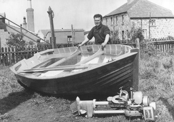 William shows off the dinghy in the back yard of 28 Seafield Street