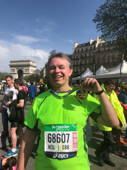 Paris Marathon Finisher with the Arc de Triomphe